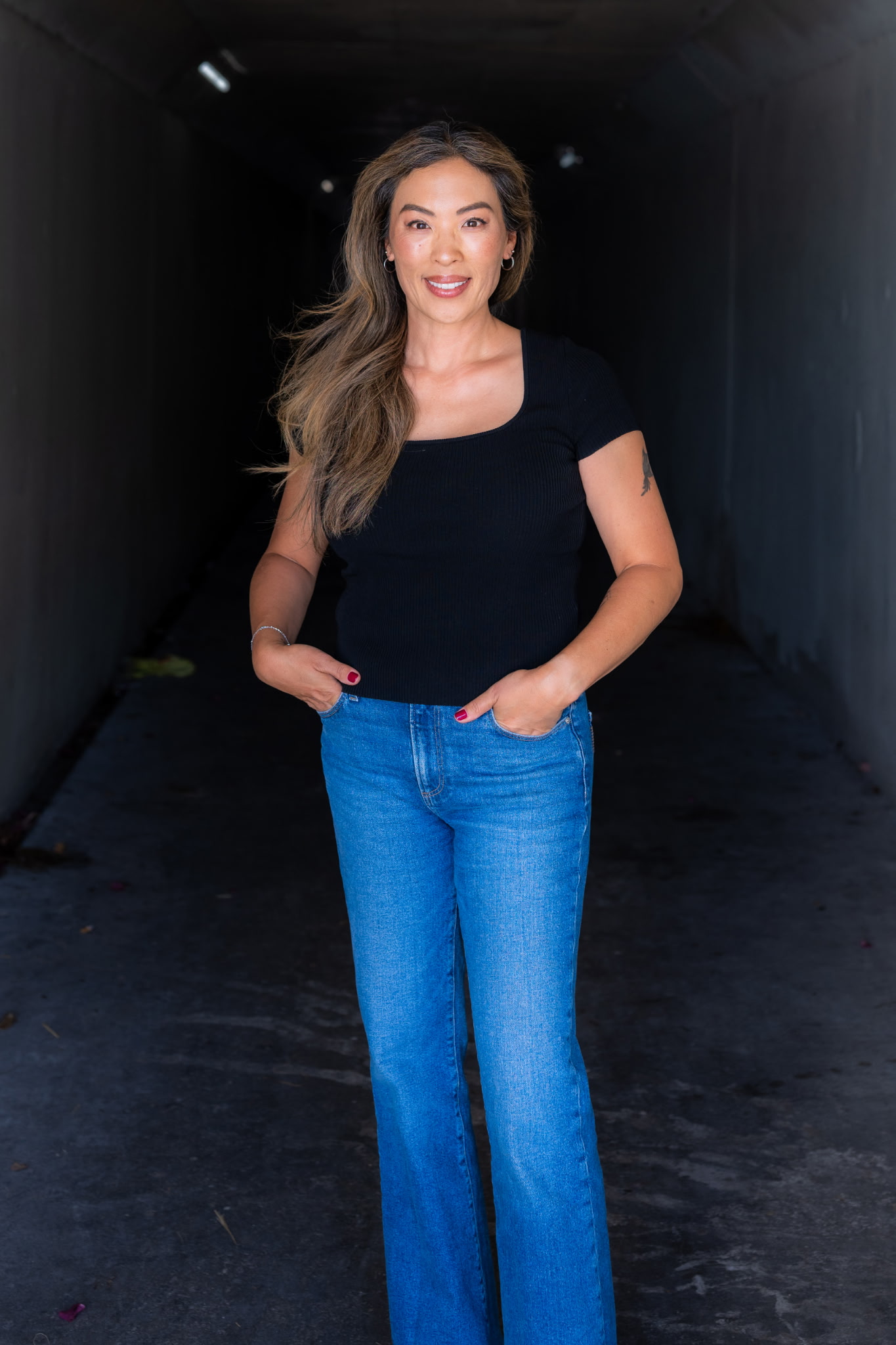 Sochin Lee, founder of Core 4 Coaching, standing in a tunnel opening toward daylight